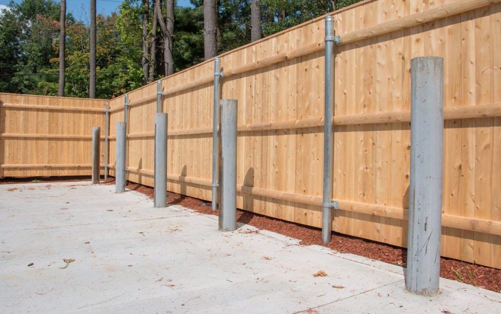 Wood to steel dumpster enclosure